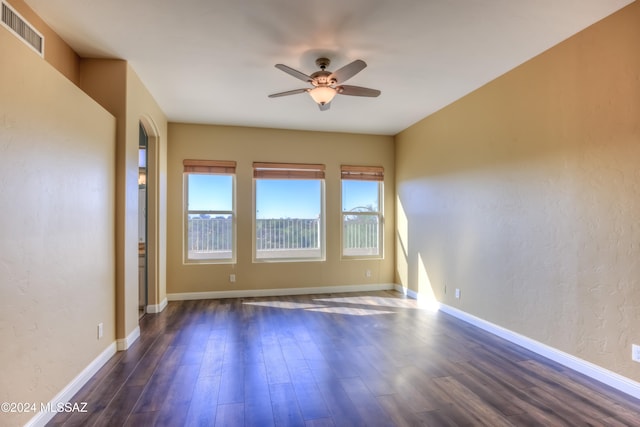 spare room with ceiling fan and dark hardwood / wood-style floors