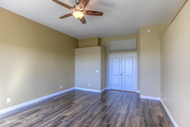 unfurnished bedroom with a closet, dark hardwood / wood-style floors, and ceiling fan