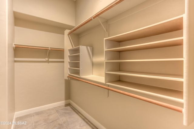 walk in closet featuring tile patterned flooring