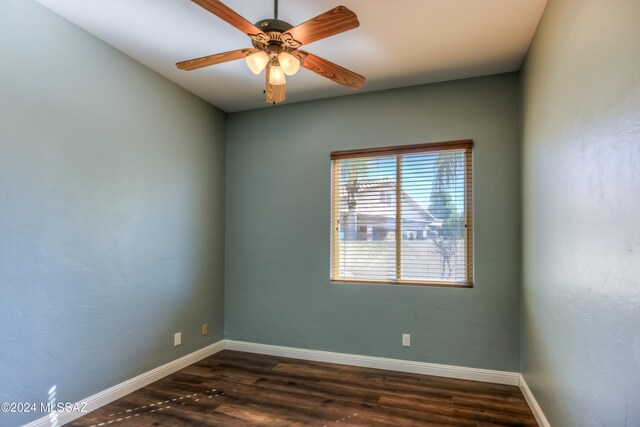 unfurnished room with dark hardwood / wood-style floors and ceiling fan