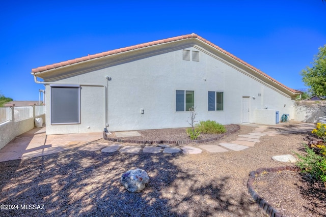 back of house with a patio