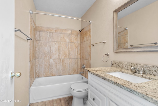 full bathroom featuring vanity, toilet, hardwood / wood-style floors, and tiled shower / bath