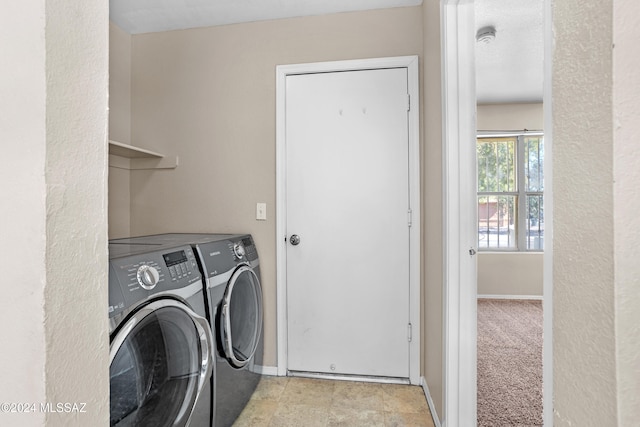 washroom featuring separate washer and dryer and light colored carpet