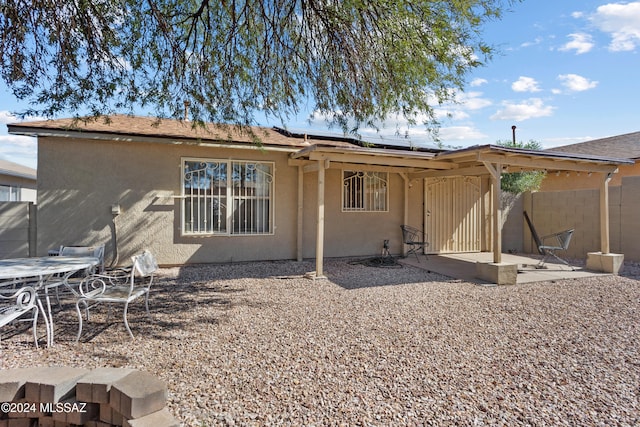 back of property featuring a patio and solar panels