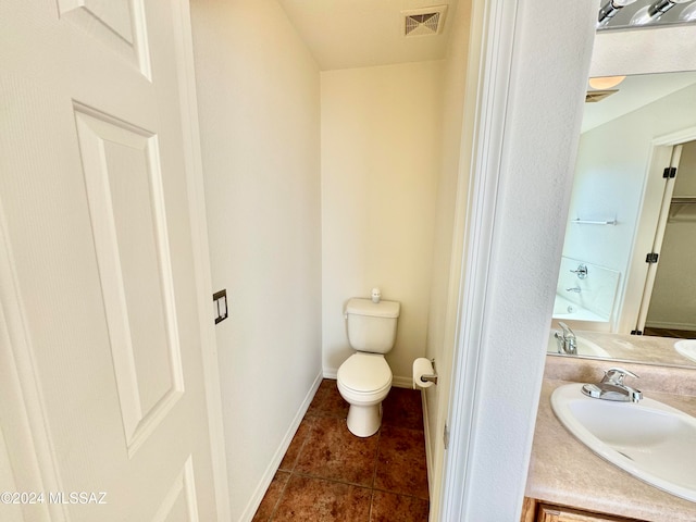 bathroom with vanity, toilet, and tile patterned flooring