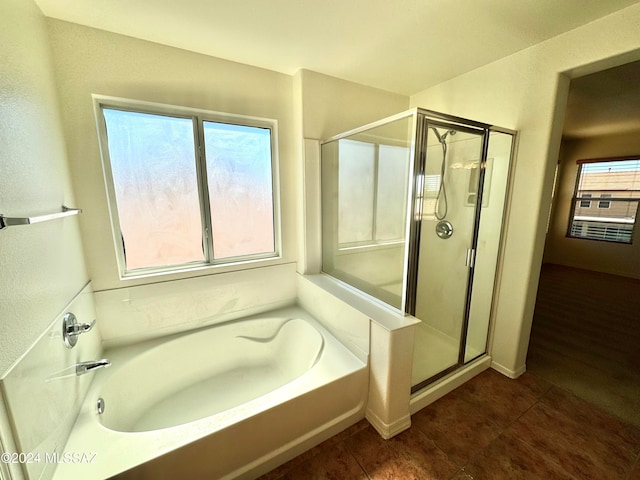 bathroom with shower with separate bathtub and a healthy amount of sunlight