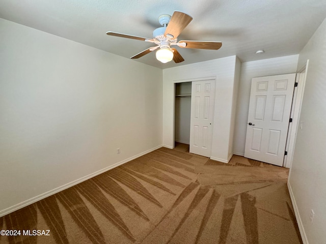 unfurnished bedroom with a closet, ceiling fan, and carpet