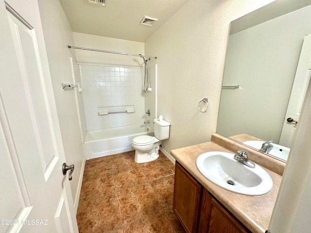 full bathroom with tiled shower / bath, vanity, toilet, and tile patterned floors