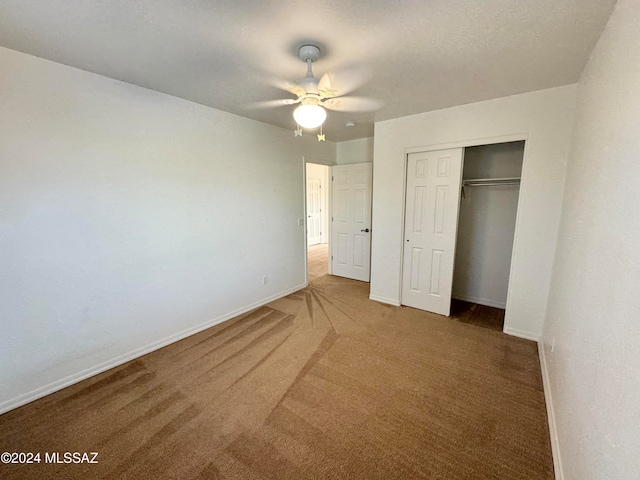 unfurnished bedroom featuring a closet, ceiling fan, and carpet