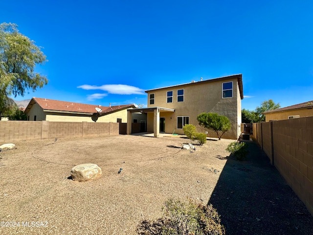 rear view of house featuring a patio