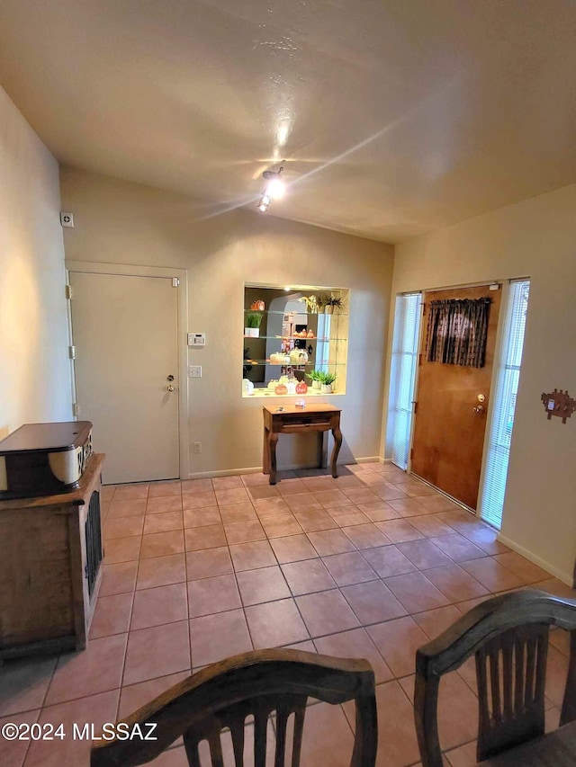 foyer entrance featuring lofted ceiling and light tile patterned floors