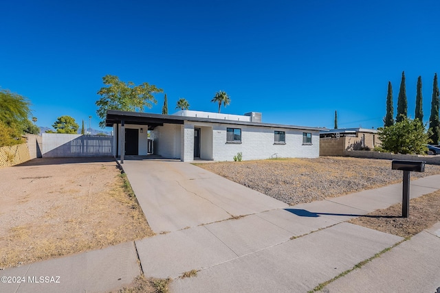 single story home featuring a carport