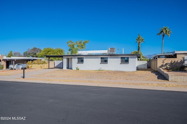 manufactured / mobile home with central AC unit and a carport