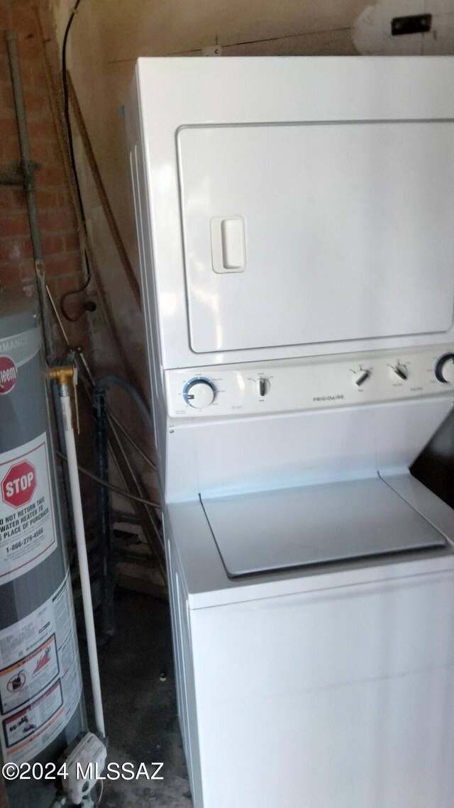 laundry room with stacked washer and dryer and gas water heater