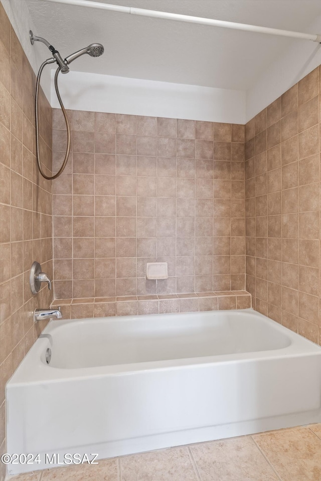 bathroom with tile patterned floors and tiled shower / bath combo