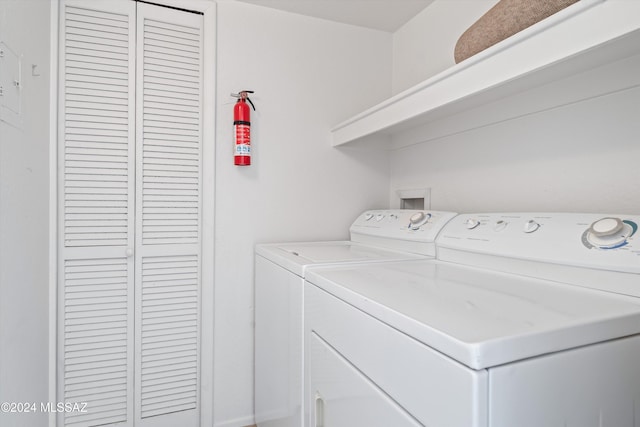 clothes washing area featuring independent washer and dryer