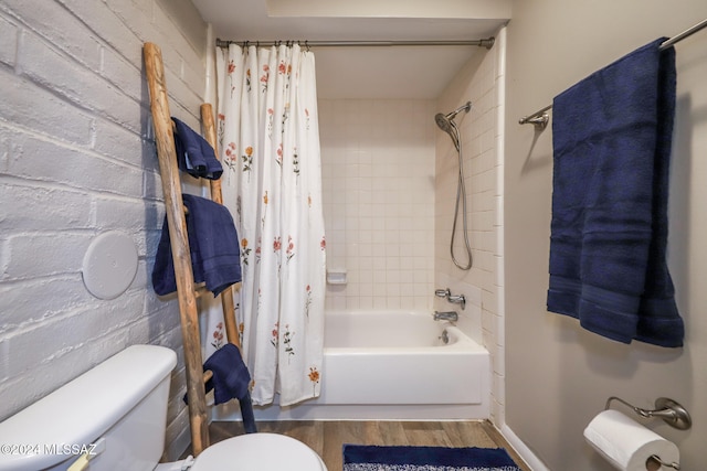 bathroom featuring shower / tub combo, hardwood / wood-style flooring, and toilet