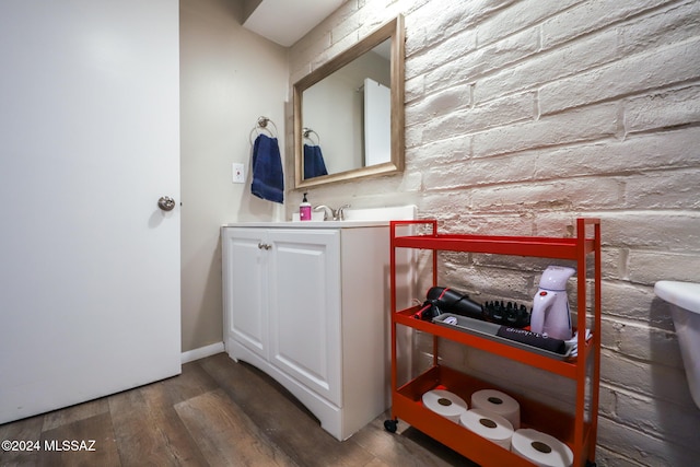 bathroom with vanity, hardwood / wood-style flooring, and toilet