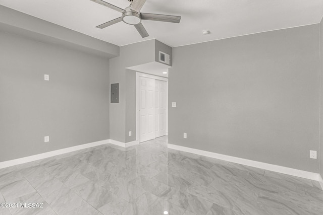 empty room with electric panel and ceiling fan