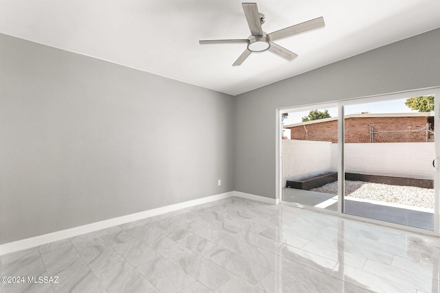 spare room featuring lofted ceiling and ceiling fan