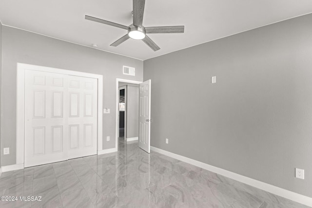 unfurnished bedroom with a closet and ceiling fan