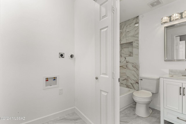 full bathroom with vanity, tiled shower / bath combo, and toilet