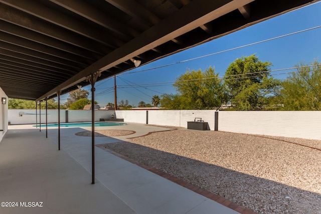 view of patio with a fenced in pool