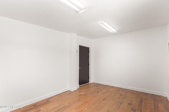 unfurnished room with wood-type flooring