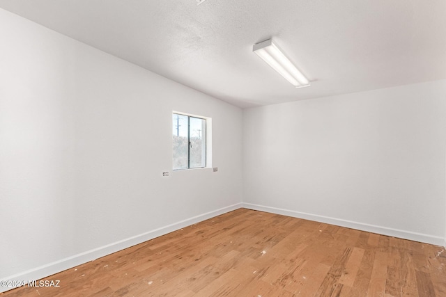 spare room featuring hardwood / wood-style floors