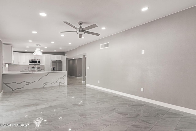 unfurnished living room featuring ceiling fan