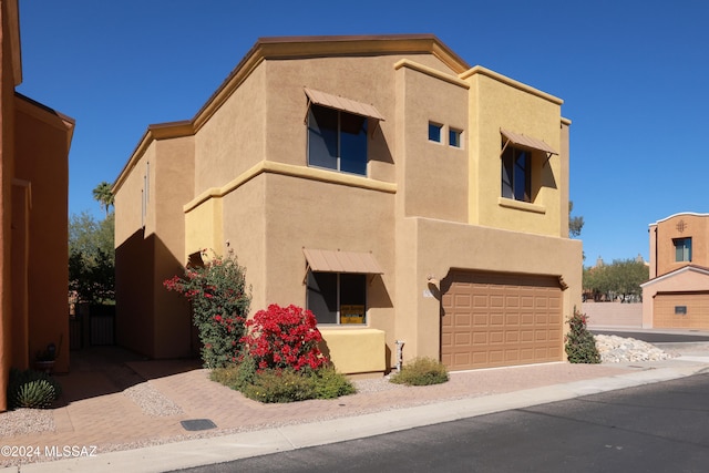 southwest-style home with a garage