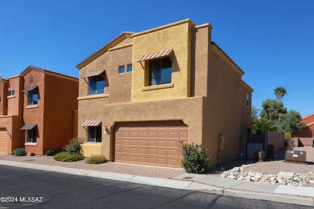 adobe home featuring a garage