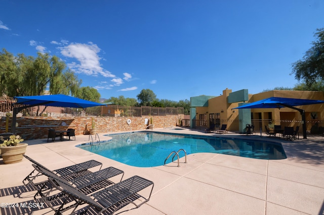 view of swimming pool featuring a patio area