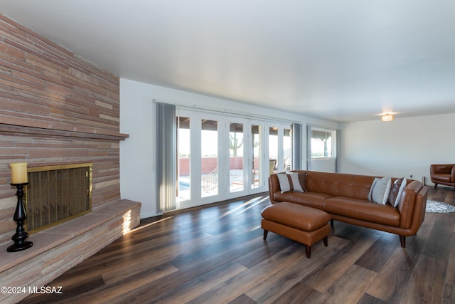 living room featuring french doors, plenty of natural light, and dark hardwood / wood-style floors