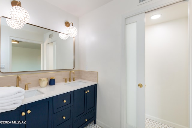 bathroom with vanity and an inviting chandelier