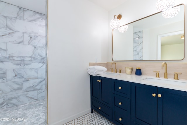 bathroom with vanity, tasteful backsplash, tile patterned floors, and tiled shower