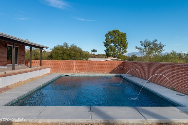 view of swimming pool with a patio and pool water feature