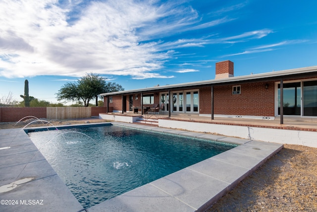 view of swimming pool featuring a patio area and pool water feature