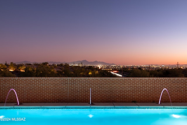 pool at dusk with a mountain view