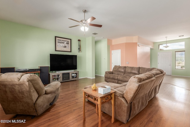 living room with wood-type flooring and ceiling fan