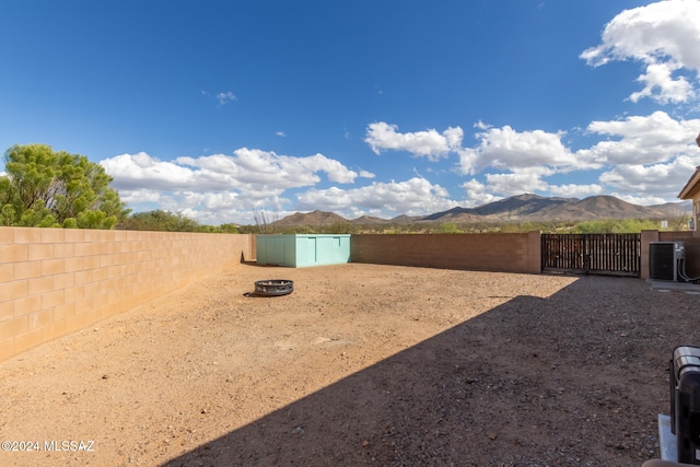 view of yard with a mountain view and central AC unit