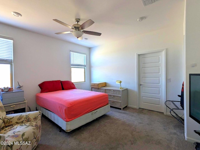 bedroom with dark colored carpet and ceiling fan