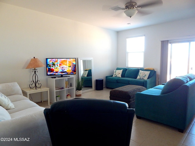 living room with light tile patterned floors and ceiling fan