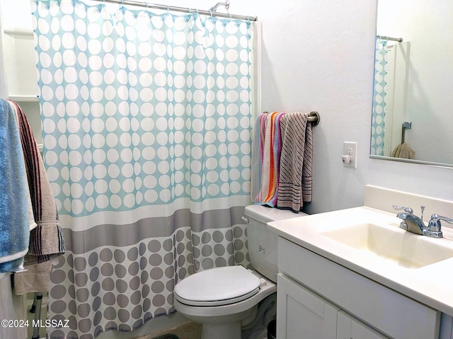 bathroom with vanity, toilet, and walk in shower