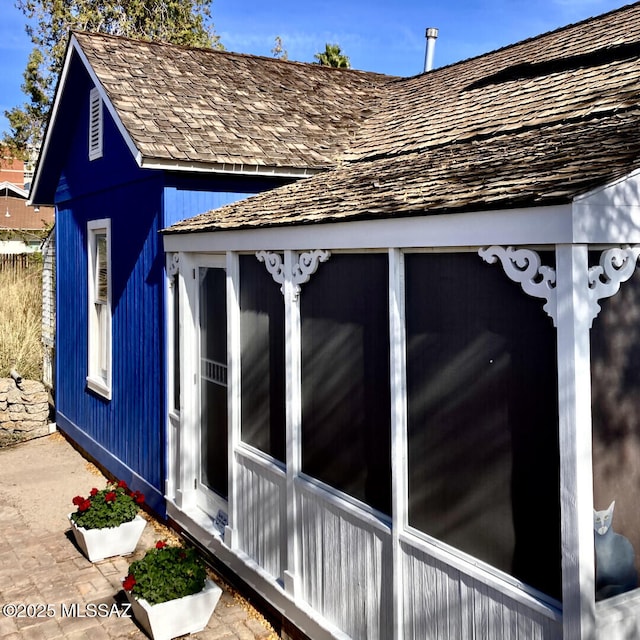 view of side of property featuring a sunroom