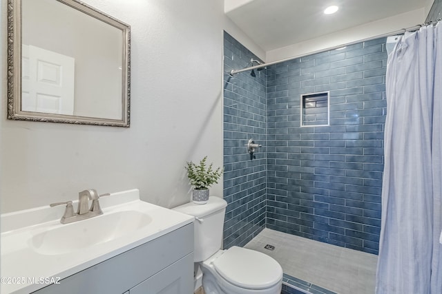 bathroom with vanity, a shower with shower curtain, and toilet