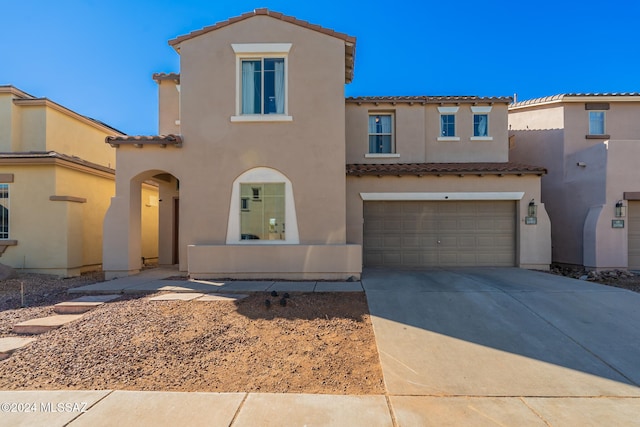 mediterranean / spanish-style home with a garage