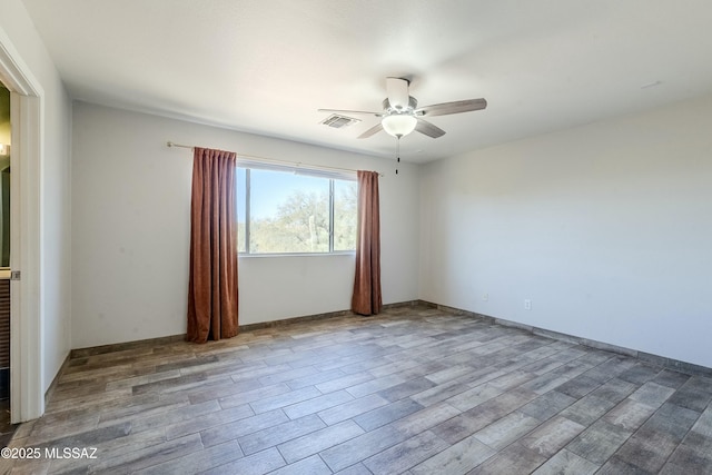 empty room with ceiling fan and wood-type flooring