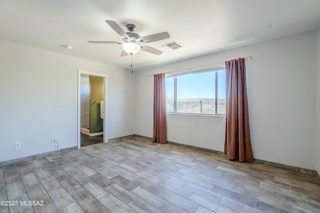 empty room featuring ceiling fan and light hardwood / wood-style flooring