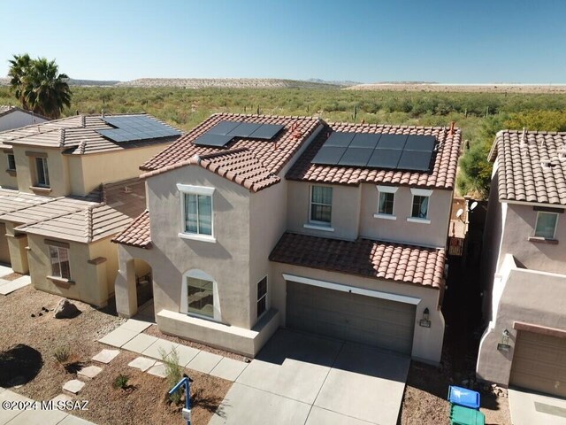 mediterranean / spanish-style home with a garage